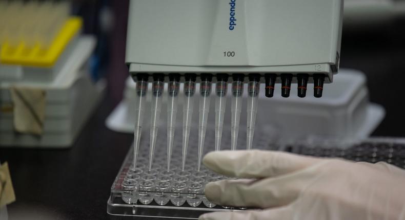 This photo taken on March 11, 2020 shows a lab techician working on a neutralising antibody test on MERS