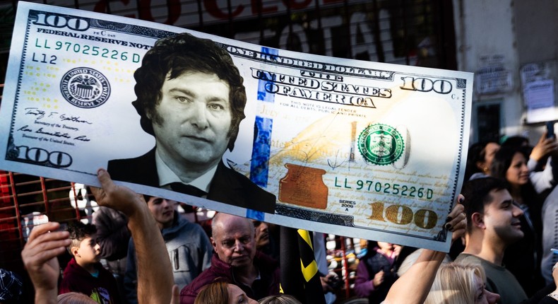 A supporter of Presidential candidate Javier Milei holds a replica of a hundred-dollar bill during a rally in September.Tomas Cuesta/Getty Images