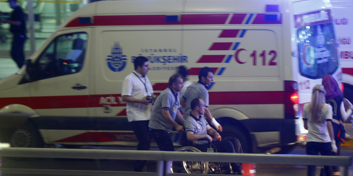Paramedics help a man in a wheelchair at Turkey's largest airport, Istanbul Ataturk, after a blast on June 28.