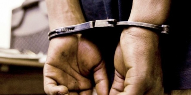 A man in handcuffs. (India.com)