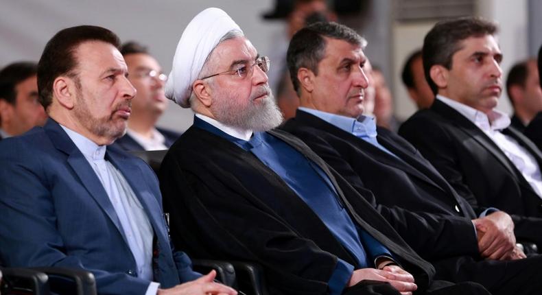 A handout picture provided by the Iranian presidency on August 27, 2019, shows President Hassan Rouhani (2 L) attending a ceremony in the capital Tehran