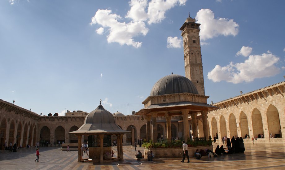 Visitors walk inside Aleppo's Umayyad Mosque in 2010.