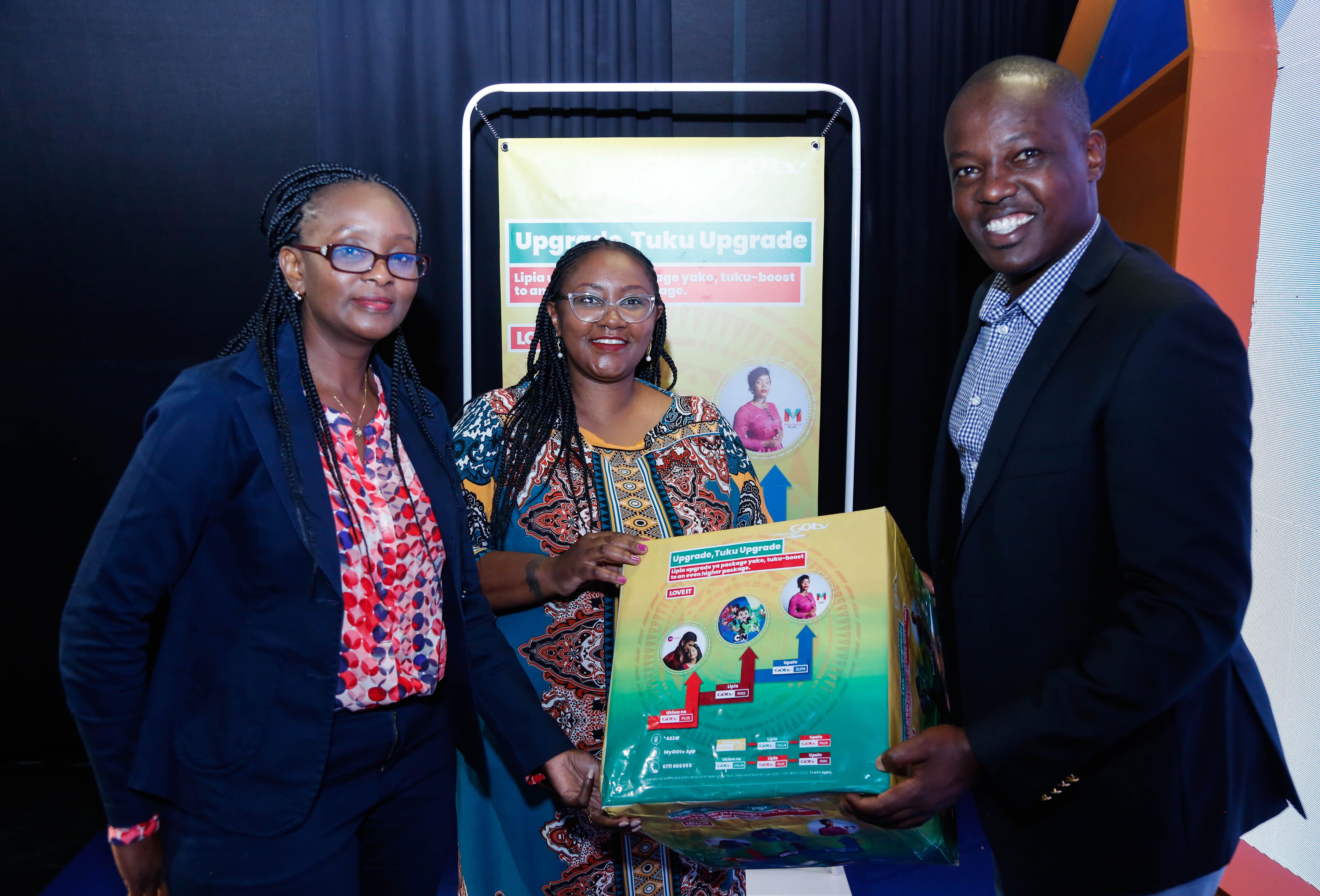Multichoice Kenya Head of Customer Value Management (CVM), Lucy Mwakalama, Head of Marketing, Celeste Muli (center) and Head of Corporate Affairs Phillip Wahome interact during the official launch of DStv and GOtv Upgrade Campaigns