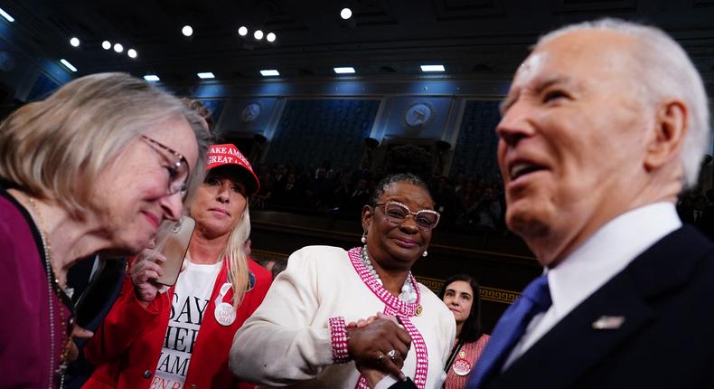Republican Rep. Marjorie Taylor Greene, left,  looks on as President Joe Biden, right, arrives to the House Chamber of the US Capitol for his third State of the Union address to a joint session of Congress in Washington, DC, on March 7, 2024.Shawn Thew/pool/AFP/Getty Images