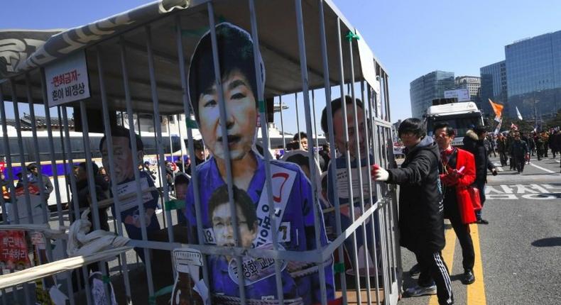 Anti-government activists celebrate in Seoul on march 10, 2017 as South Korean President Park Geun-Hye is fired by the country's top court