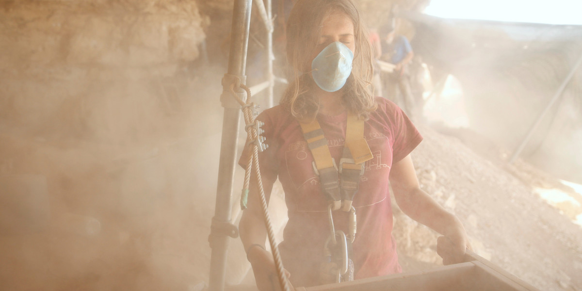 A volunteer with the Israel Antiquities Authority works at the Cave of the Skulls, an excavation site in the Judean Desert near the Dead Sea.