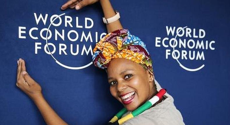 A woman strikes a pose with the WEF logo