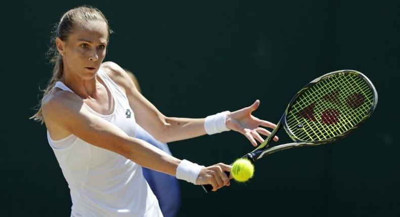 Slovakia's Magdalena Rybarikova returns against Croatia's Petra Martic at Wimbledon on July 10, 2017