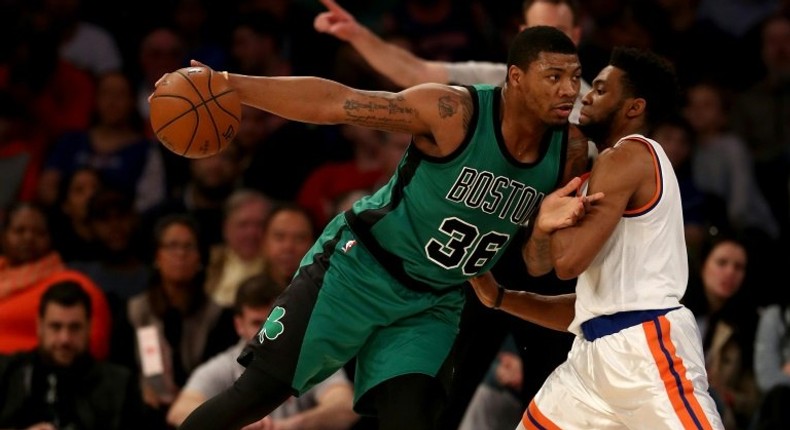 Marcus Smart (L) of the Boston Celtics drives as Chasson Randle of the New York Knicks defends on April 2, 2017