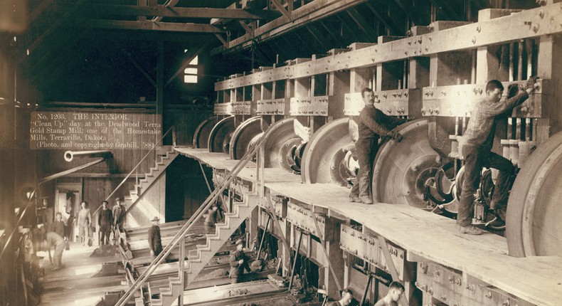 Men working on equipment at a mill circa 1900.Heritage Art/Heritage Images via Getty Images