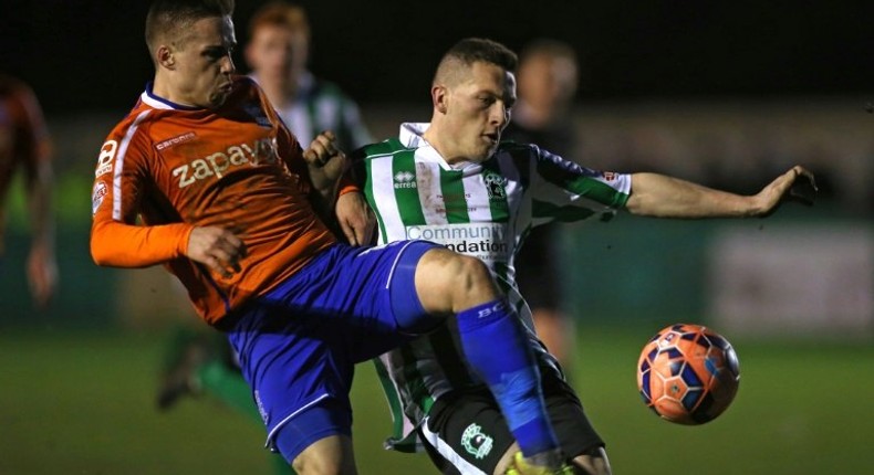 Birmingham City's English defender Mitch Hancox (left) vies with Blyth Spartans' English striker Daniel Maguire during their English FA Cup match in Blyth on January 3, 2015