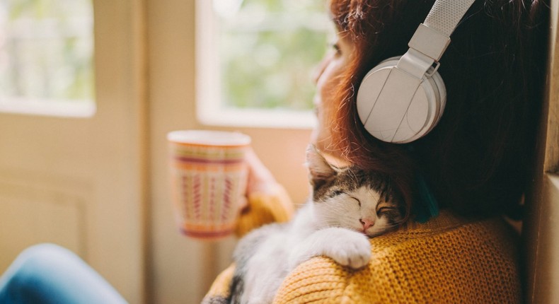 Snuggling a pet, listening to music, and having a warm drink may help boost your mood when you don't want to do anything.Martin-dm / Getty Images