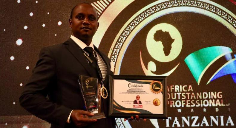 Makueni County Assembly Speaker Douglas Mbilu with his award in Tanzania