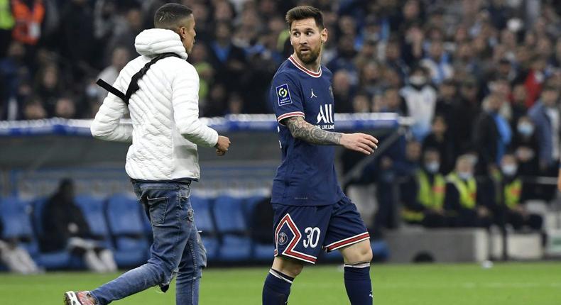 A young man invaded the pitch during Marseille's draw with PSG and approached Lionel Messi before being escorted off Creator: NICOLAS TUCAT