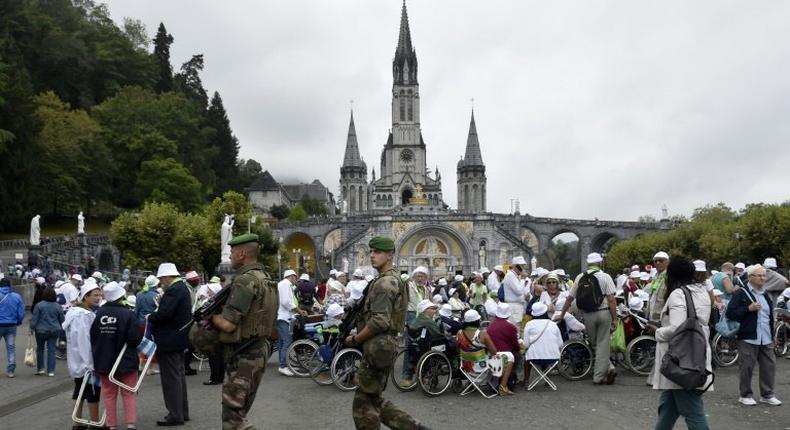 In keeping with security protocols in terror-scarred France, 300 police officers and soldiers were deployed to protect the worshippers in Lourdes, who were searched upon entry to the site