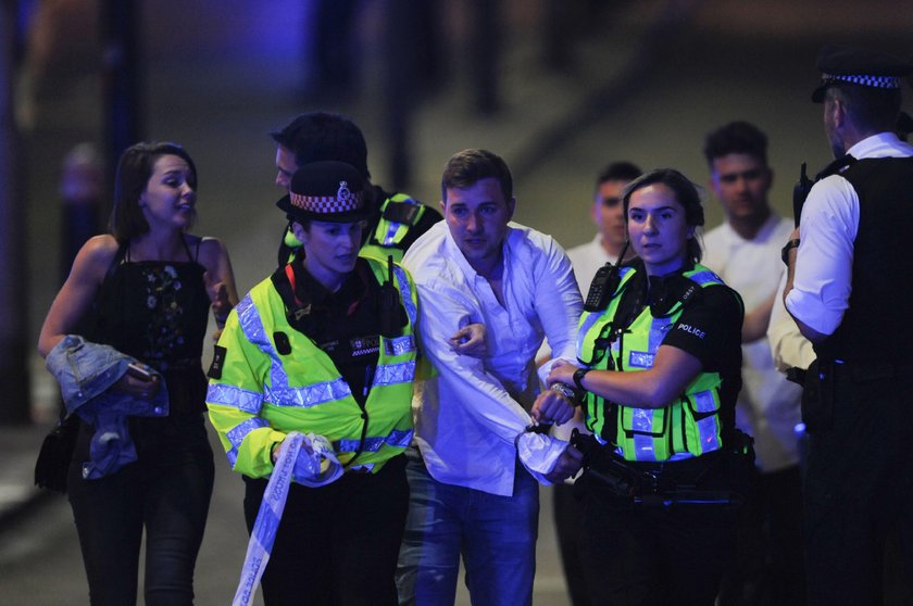 Police entering a bar in London telling people to get down in this screen grab from video