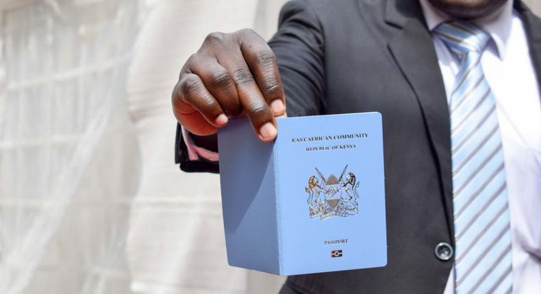 A man holding a Kenyan passport