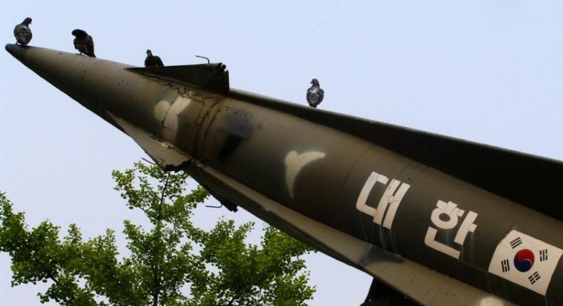 Pigeons sit on a South Korean missile on display at the Korea War Memorial Museum in Seoul