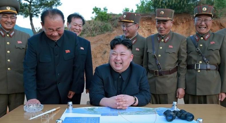 North Korean leader Kim Jong Un reacts during the long-range strategic ballistic rocket Hwasong-12 (Mars-12) test launch.