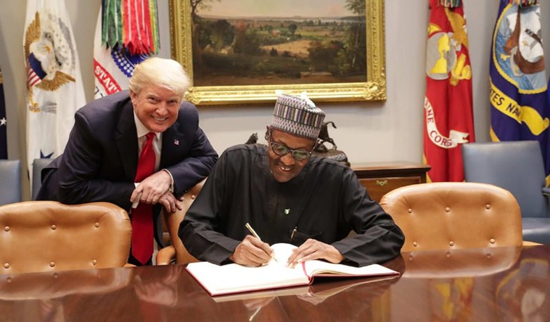 President Donald Trump (L) and President Buhari (R) sign a raft of bilateral agreements at the White House on April 30, 2018 (White House media)