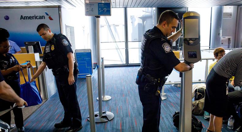 facial recognition U.S. Customs and Border Protection officers move facial recognition scanners at a gate inside Terminal 3 before an American Airlines flight to London Heathrow was scheduled to board on Wednesday, July 19, 2017 at O'Hare International Airport. (Brian Cassella/Chicago Tribune/Tribune News Service via Getty Images)