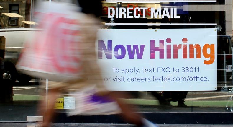 A Now Hiring sign is displayed on a shopfront on August 5, 2022 in New York City.John Smith/VIEWpress/Getty Images