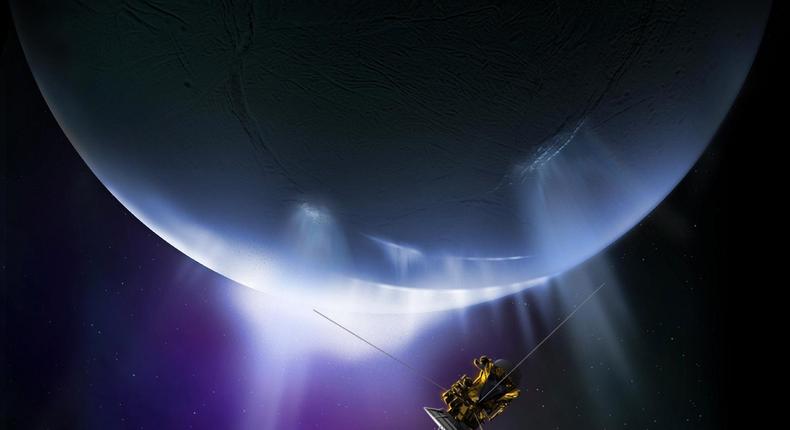 An illustration of NASA's Cassini spacecraft flying through the water plumes of Enceladus, an icy moon that orbits Saturn.