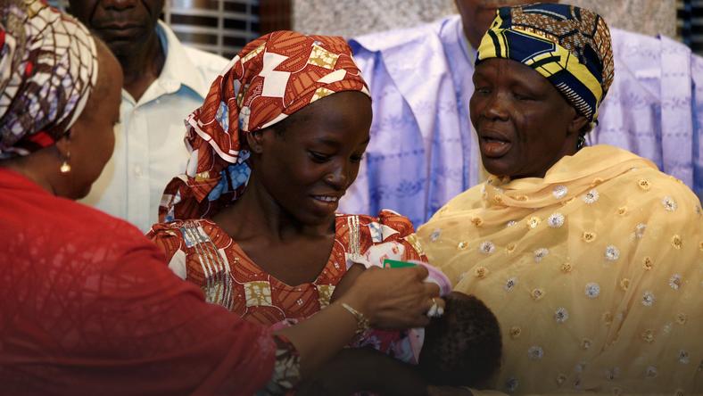 Amina Ali Darsha Nkeki carries her child during her visit to meet President Muhammadu Buhari in Abuja