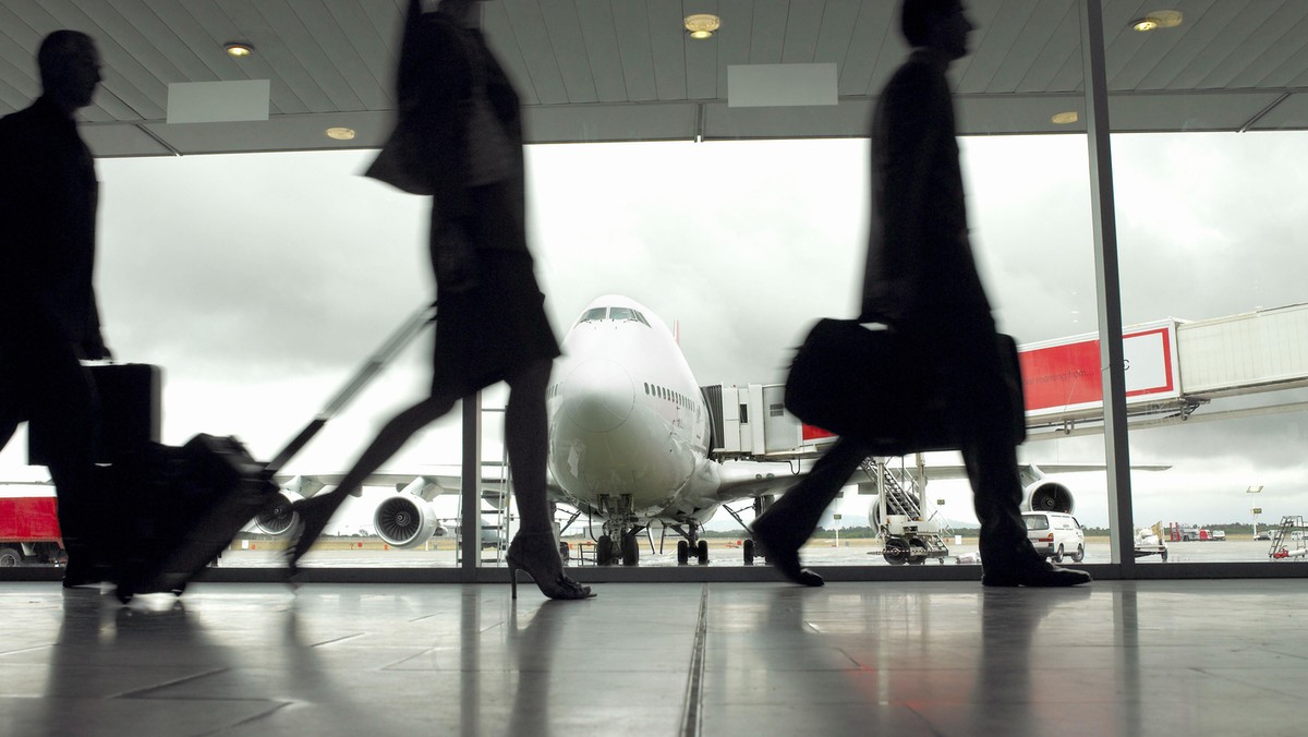 People walking through airport, silhouette (focus on aeroplane)