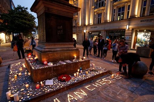 People attend a vigil for the victims of last week's attack at a pop concert at Manchester Arena, in