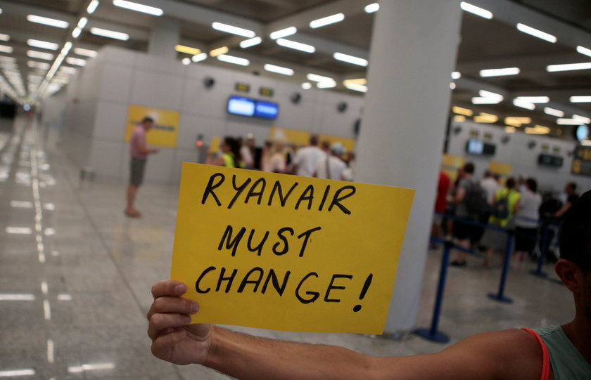 Ryanair employees show their shirts during a protest on the first day of a cabin crew strike held in