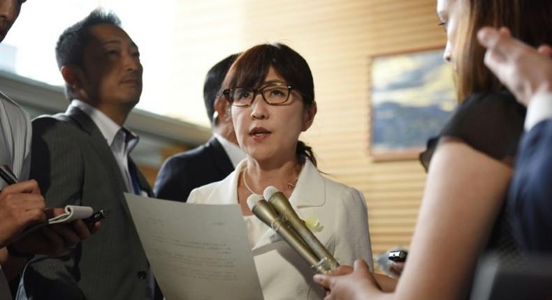 Japan's Defence Minister Tomomi Inada (C) will resign over an alleged coverup involving military documents