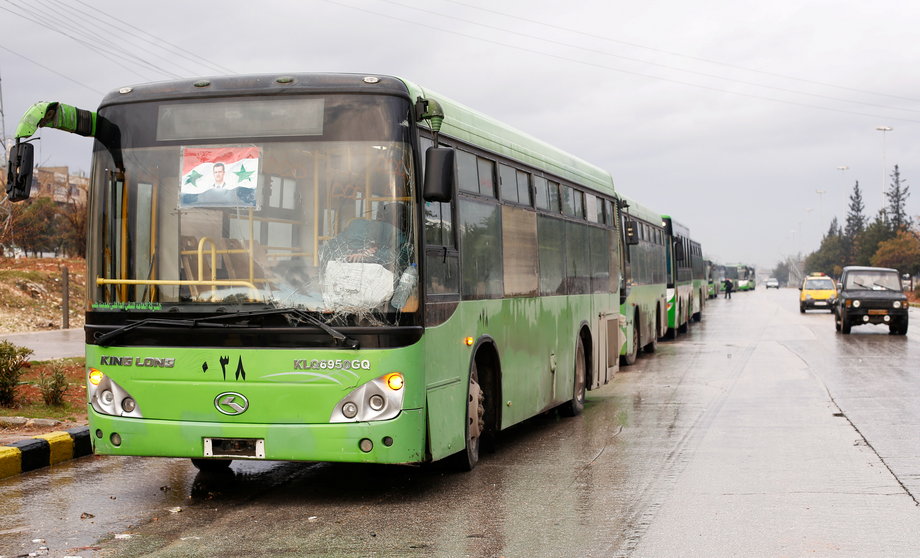 Buses wait to evacuate people from a rebel pocket in Aleppo, in the government-controlled al-Hamadaniah Stadium of Aleppo, Syria December 14, 2016.