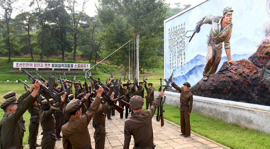 North Koreans signing up to join the army in an undated photo released by North Korea's Korean Central News Agency in Pyongyang.