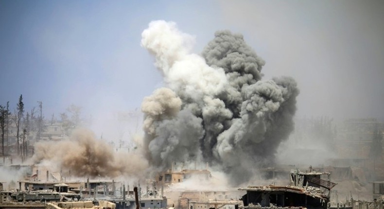 Smoke rises from buildings following a reported air strike on a rebel-held area in the southern Syrian city of Daraa, on May 22, 2017