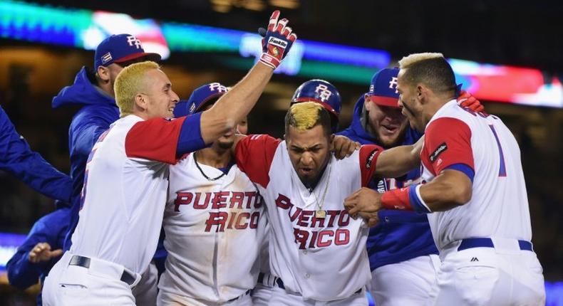 Eddie Rosario of Puerto Rico celebrates with teammates after getting the game-winning hit in the 11th inning for a 4-3 win over the Netherlands, at Dodger Stadium in Los Angeles, on March 20, 2017