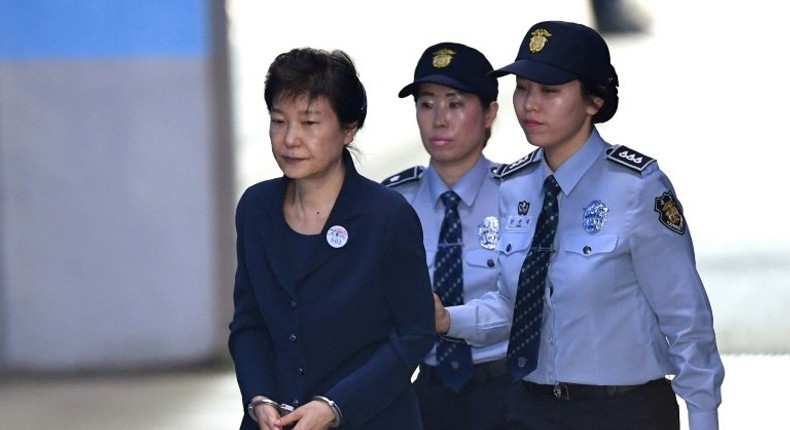 South Korean ousted leader Park Geun-Hye (left) arrives at the Seoul Central District Court in Seoul on May 25, 2017 for her trial over the massive corruption scandal that led to her downfall