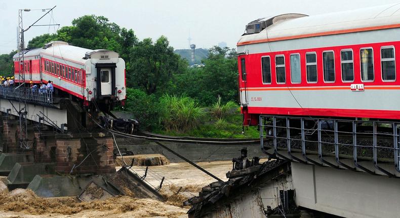 A passenger train is seen on a partially destroyed railway bridge after two of its carriages fell into the river in Xiaohan town of Guanghan, Sichuan province August 19, 2010. Two train carriages fell into a river in southwestern China on Thursday after floods destroyed a bridge, but the passengers had been evacuated before the accident happened, state television said.