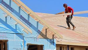 A roofer is seen working on a condominium in Canterbury Crossing on a hot day Tuesday, Aug. 11, 2020 in Latham, N.Y.Lori Van Buren/Getty Images