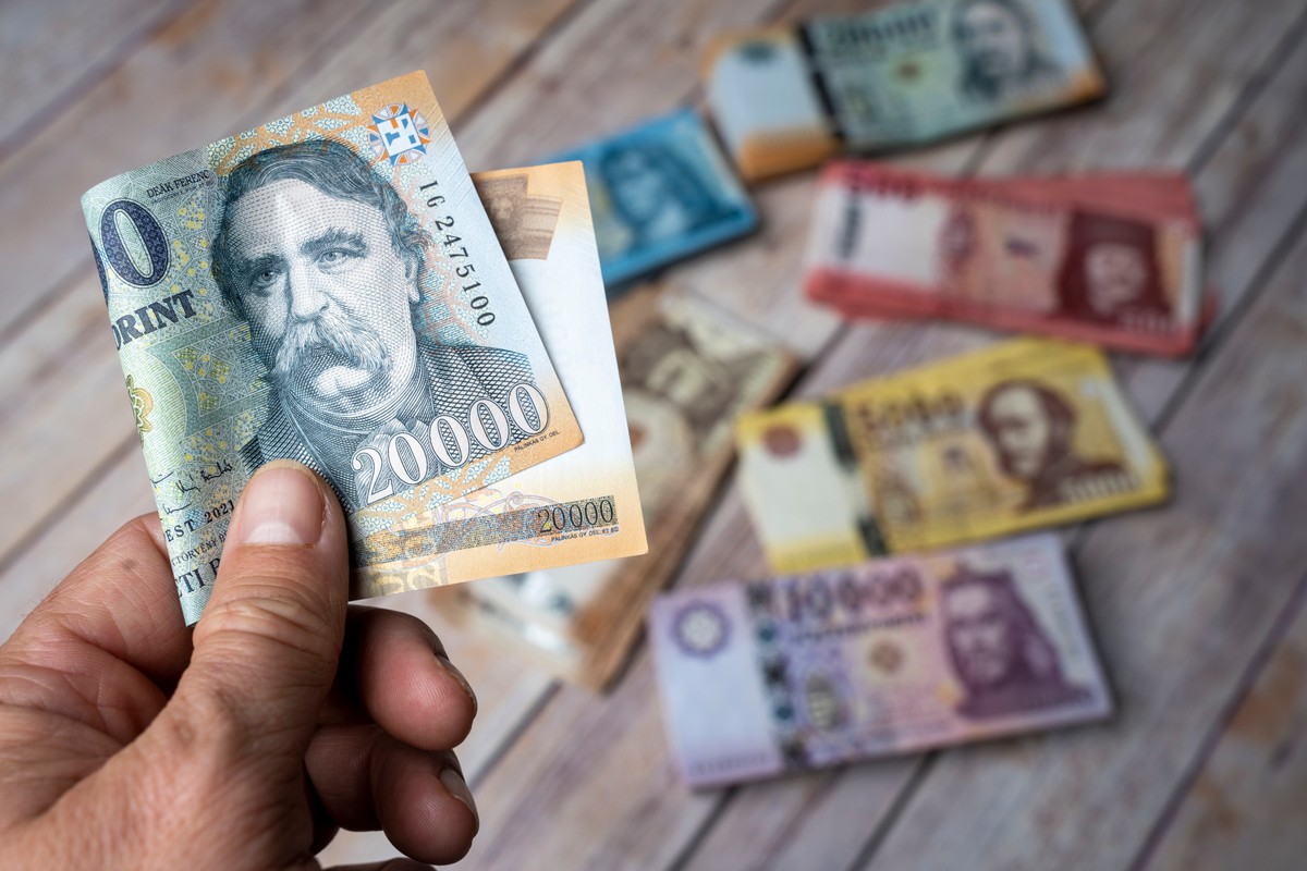 Hungarian,Paper,Banknote,In,A,Man's,Hand.,Stack,Of,Money