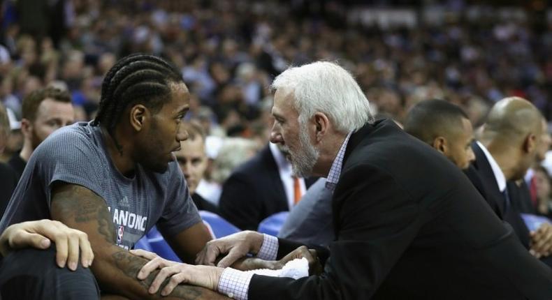 Head coach Gregg Popovich of the San Antonio Spurs talks to Kawhi Leonard during a NBA game in Sacramento, California