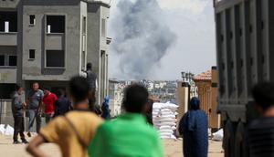 Palestinians watch smoke rise in Rafah. Israel has warned civilians to evacuate the eastern part of the city.Reuters