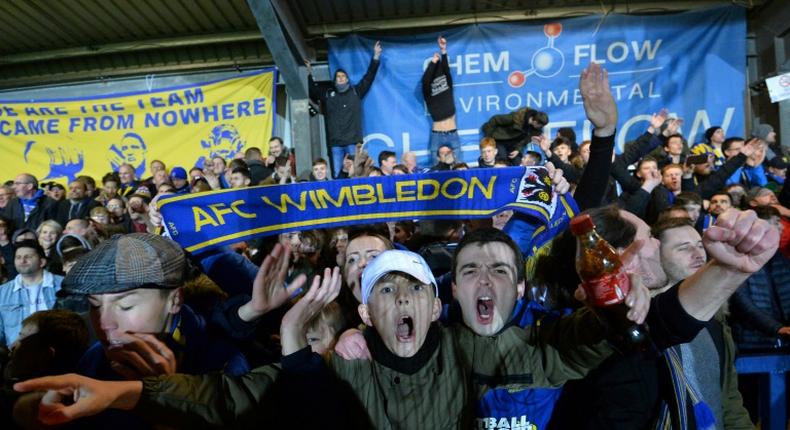 Up for the Cup: AFC Wimbledon fans celebrate their 4-2 victory over West Ham in the fourth round of the FA Cup