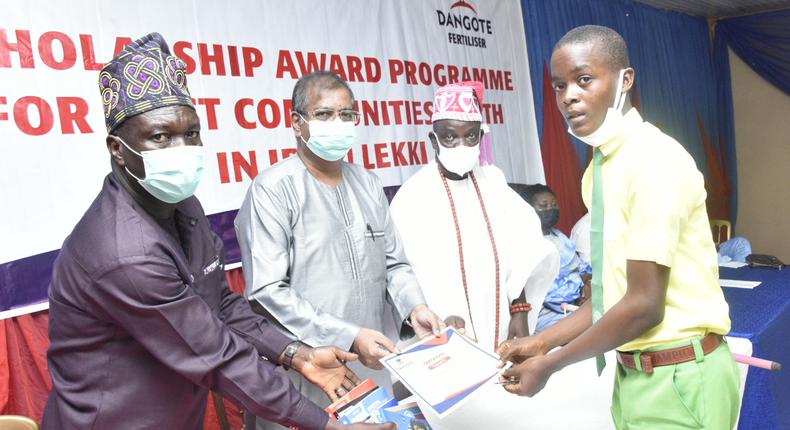 L-R: Chairman, ANCOPSS Ibeju-Lekki  Zone Lagos, Ogunnowo Fatai; Dangote Industries Limited, Group Executive Director, Strategy, Capital Projects and Portfolio Development, Dangote Industries Limited, Devakumar Edwin; HRM, Oba Olumuyiwa Ogunbekun, Onilekki of Lekki Land; and David Adefuye,  one of the beneficiary students of Community Senior High School, Magbon Segan, at the Dangote Oil Refinery Projects and Fertilizer Limited, Presentation of Scholarship Awards Programme for the Host Communities' Youth in Ibeju-Lekki, Lagos on Monday, December 6, 2021