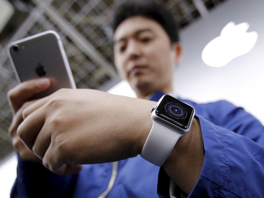 Customer Tomoyoshi Fujimura sets up his Apple Watch, which is to be paired with his iPhone, after buying it at an electronics store in Tokyo April 24, 2015.