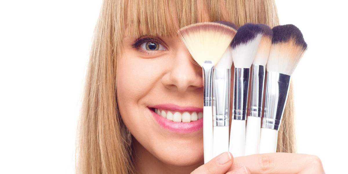 Beauty Girl with Makeup Brushes