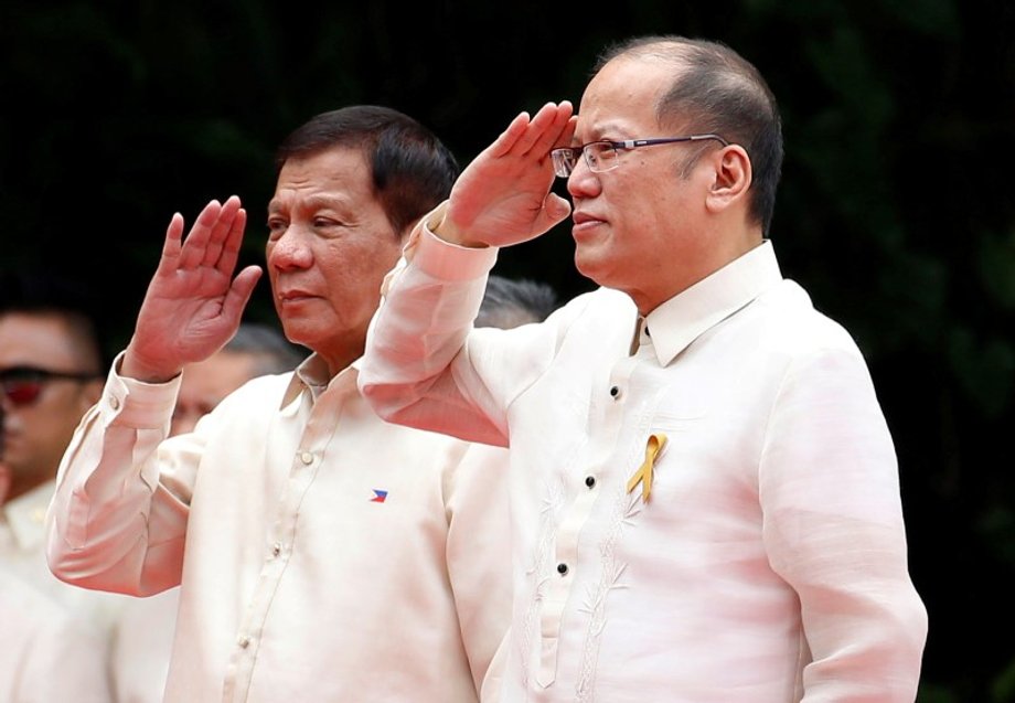 Incoming President Rodrigo Duterte and outgoing President Benigno Aquino salute the honor guards before Aquino leaves the Malacanang Palace in Manila.