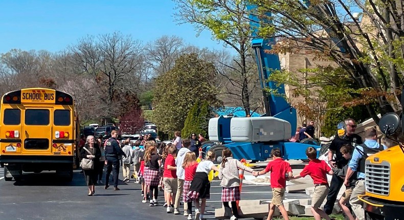 Children from The Covenant School, a private Christian school in Nashville, Tenn., hold hands as they are taken to a reunification site at the Woodmont Baptist Church after a shooting at their school, on Monday March, 27, 2023.AP Photo/Jonathan Mattise