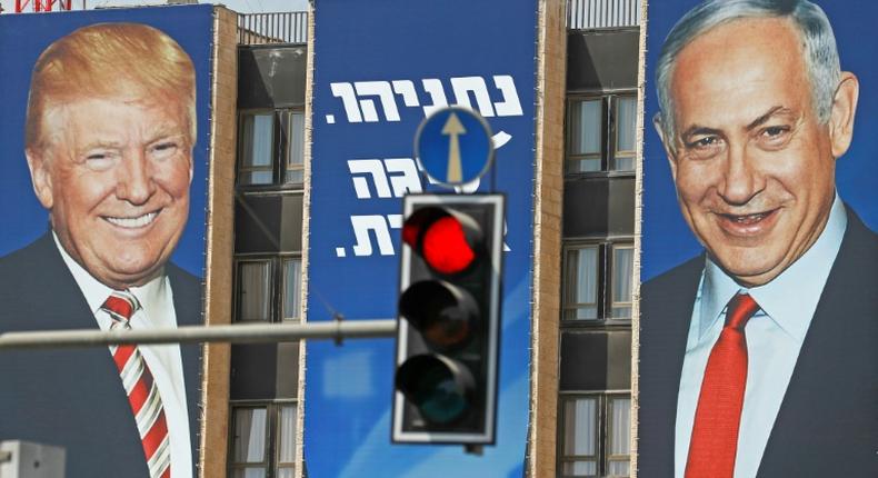 This picture taken on September 14, 2019 shows an Israeli election banner bearing the portraits of US President Donald Trump (L) and Prime Minister Benjamin Netanyahu hanging on a building facade in Jerusalem