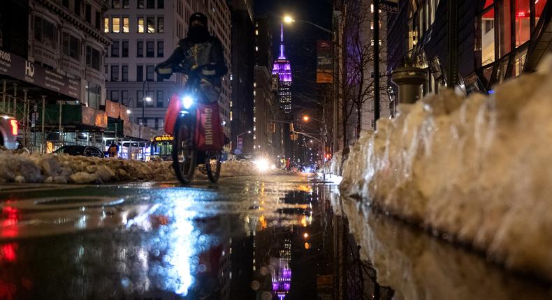 A Grubhub delivery driver rides near the Empire State Building on February 04, 2021 in New York City.
